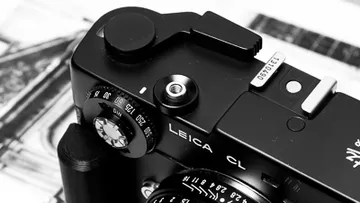 Black Leica camera close-up on papers.