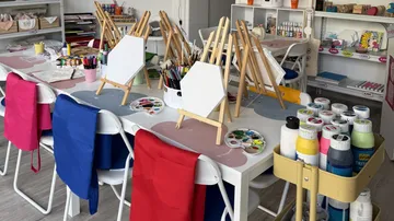 Art studio tables prepare for painting activity.