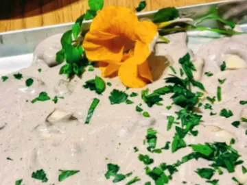 Creamy dip topped with herbs and edible flowers.