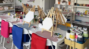 Art studio with easels and paint supplies.