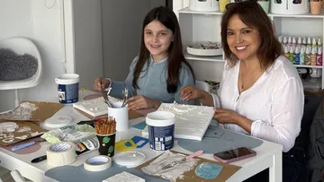 Two women crafting at a table together.