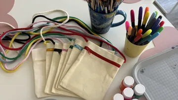Craft supplies on white table surface.
