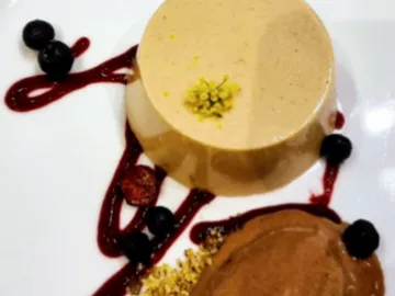 Delicious dessert with mousse and berries on a plate.