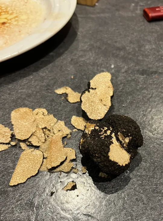 Sliced truffle on dark kitchen counter.
