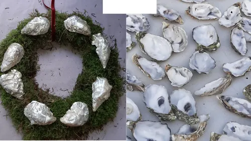 Moss wreath with silver shells on table.