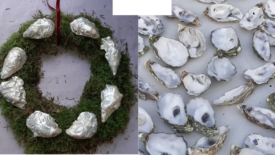 Moss wreath with silver shells on table.
