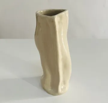 Ceramic vase standing on a white table.