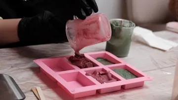 Person pours mixture into silicone mold.
