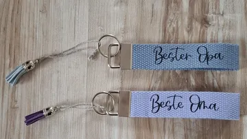 Two keychains on a wooden surface.