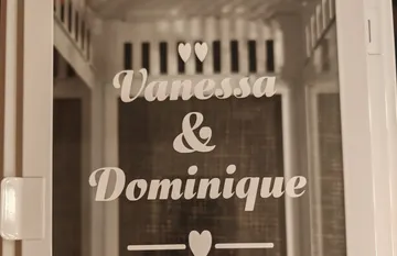 Glass door displays names with hearts design.