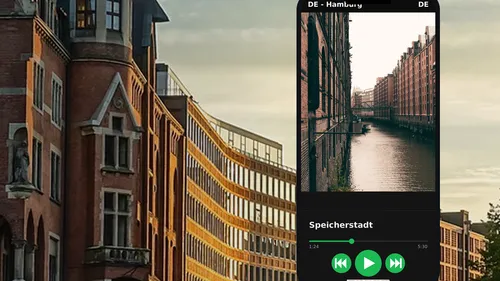 Smartphone displays canal and brick buildings.