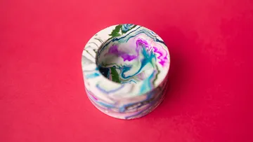 Marbled bowl on solid pink background.