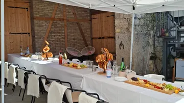 Tables set with food in outdoor courtyard