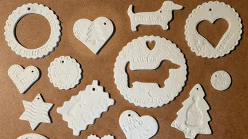 White clay ornaments on a wooden surface.