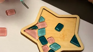 Colorful tiles placed on wooden star base.