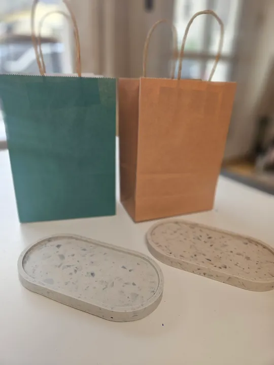 Two trays and bags on white surface.
