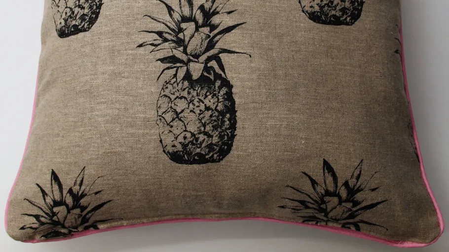Brown cushion with black pineapples design.