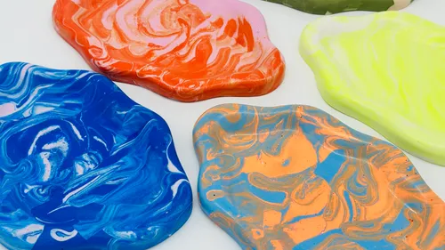 Colorful paint blobs on white surface.