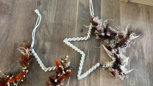 Dried flower garland on wooden table.