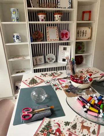 Craft supplies on table in decorated room.