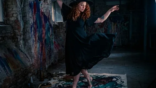 Woman dancing on painted floor, artistic room.