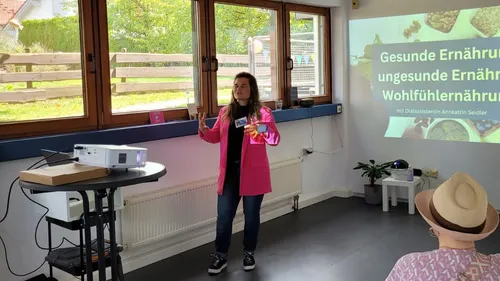 Person präsentiert vor Projektionsleinwand.