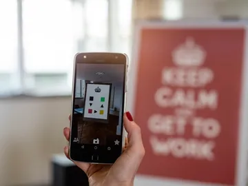 Smartphone holds an image with geometric shapes in its hand.