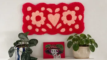 Red and pink wall art with plants.