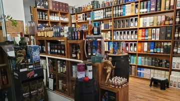 Bottles displayed on shelves in liquor store.