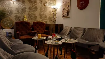 Plush seating with drinks and table decor.