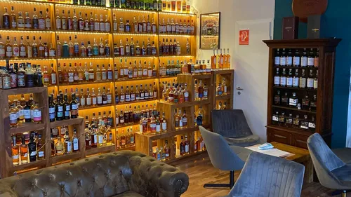 Shelves filled with liquor bottles in lounge.