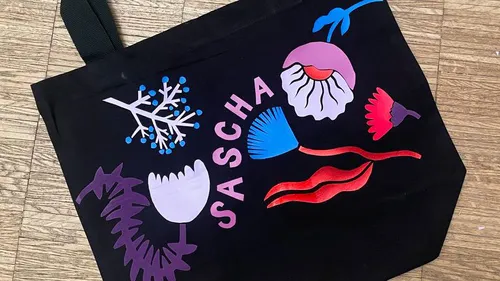 Tote bag with colorful floral designs.