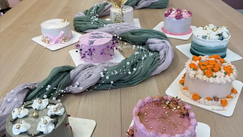 Mini cakes on table, decorative floral theme.