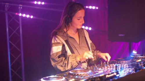 DJ spielt mit Ausrüstung auf der Bühne.