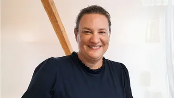 Person smiling in a bright indoor setting.
