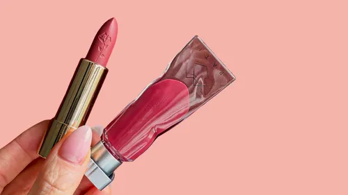 Lipstick and tube held against pink background.