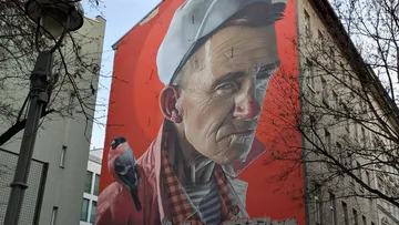 Giant mural of elderly man on building