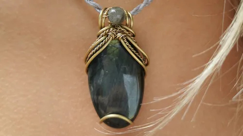 Labradorite pendant on a person's neck.