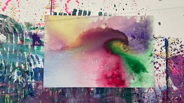 Abstract painting with vibrant colors on wall.