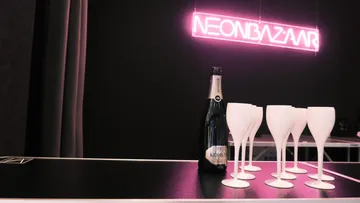 Champagne bottle and glasses on counter.