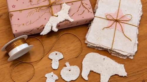 Craft paper animals beside wrapped gift.