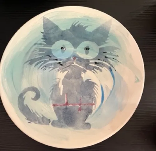 Plate with abstract blue cat illustration.
