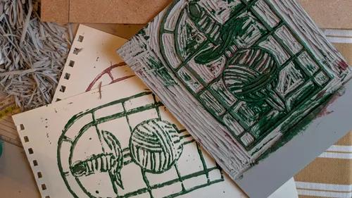 Linoleum block and print on table.