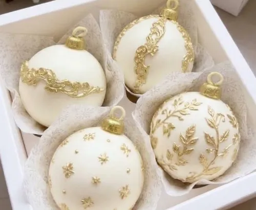Ornaments with gold designs in box.