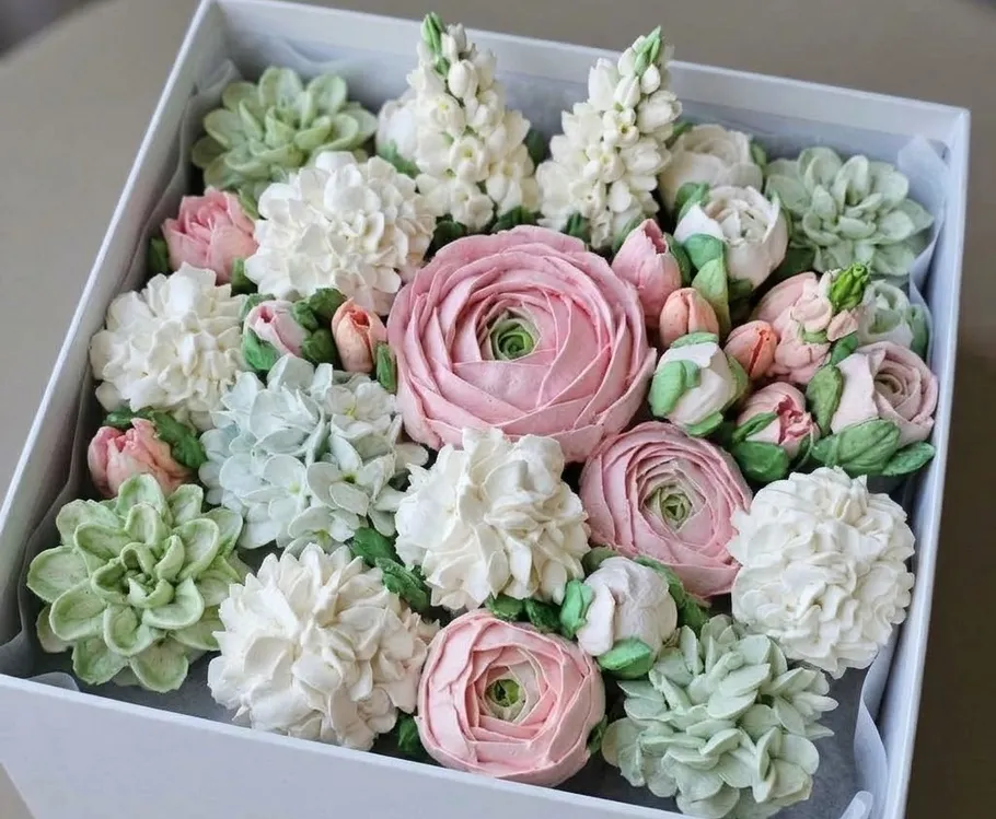 Floral arrangement with pink, white blooms in box.