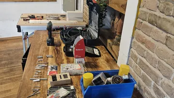 Workbench with tools and supplies in workshop.