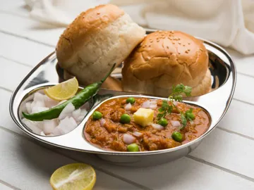 Platter with colorful rolls and spicy lentil sauce.