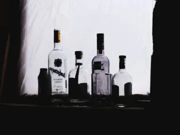 Bottles stand against a bright background light.
