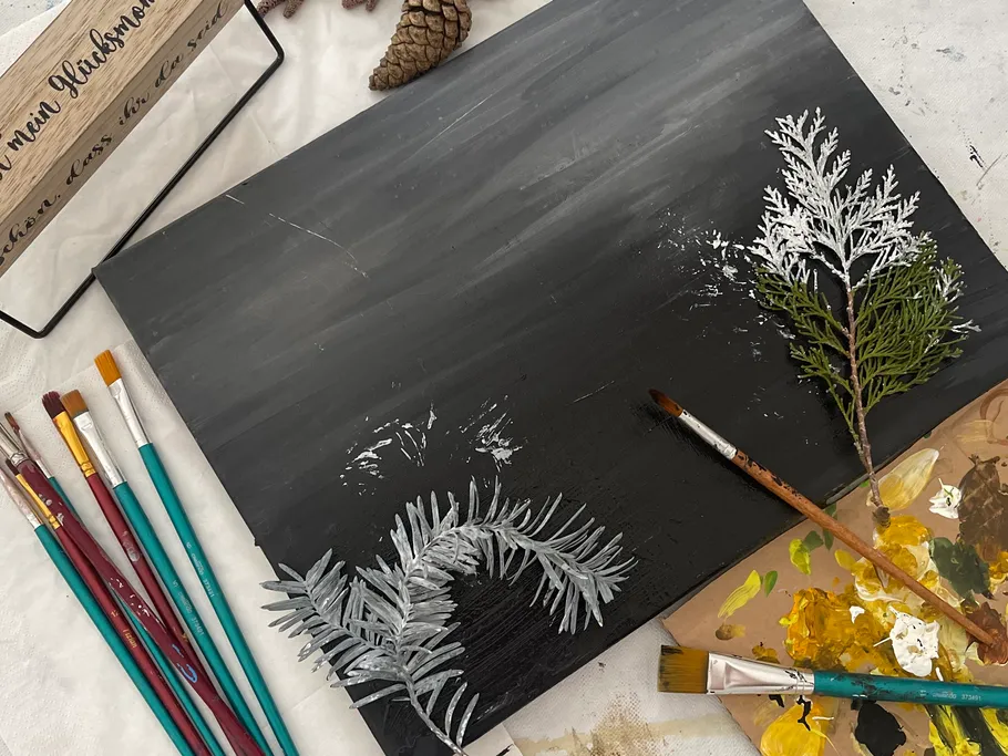 Canvas, brush and paint residue on a table.