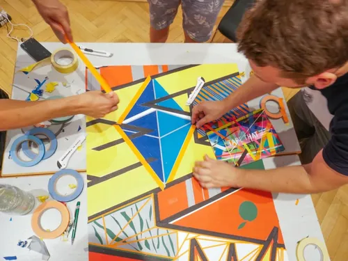 Colourful art project: People create a geometric surface.